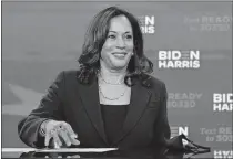  ??  ?? Democratic presidenti­al candidate former Vice President Joe Biden's running mate Sen. Kamala Harris, D-Calif., looks up as she signs required documents for receiving the Democratic nomination for president and vice president of the United States, Friday in Wilmington, Del. [CAROLYN KASTER/ THE ASSOCIATED PRESS]