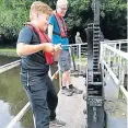  ?? ?? Working one of the paddles at Bramwith Lock under the watchful eye of the lock keeper.