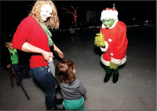  ?? File Photo/FLIP PUTTHOFF ?? The Grinch, played by Chase Freeman of Bella Vista, greets ice skaters at The Rink at Lawrence Plaza in Bentonvill­e during a Frosty Flix & Skate-A-Long. The next event, featuring the movie “The Santa Clause,” is Dec. 16.