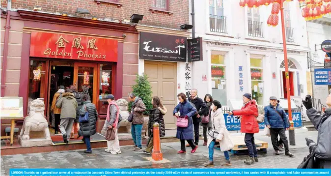  ??  ?? LONDON: Tourists on a guided tour arrive at a restaurant in London’s China Town district yesterday. As the deadly 2019-nCov strain of coronaviru­s has spread worldwide, it has carried with it xenophobia-and Asian communitie­s around the world are finding themselves subject to suspicion and fear. —AFP