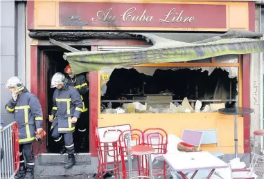  ??  ?? Firefighte­rs leave the bar where a fire broke out during a birthday celebratio­n. The blaze in Au Cuba Libre bar in Rouen, western France, yesterday killed 13 people and injured six others