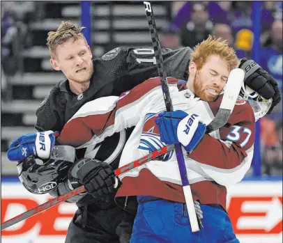  ?? Chris O’meara The Associated Press ?? Tampa Bay right wing Corey Perry, left, and Colorado left wing J.T. Compher scrap during the second period on Saturday. The two Stanley Cup contenders have gotten off to slow starts.