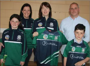  ??  ?? James Hickey of James Hickey Kitchens and Bedrooms, Ballyvourn­ey and his family presenting Féile jerseys to members and mentors of the Laochre Óg U14 Camogie team due to take part in Féile in Carlow later this month.