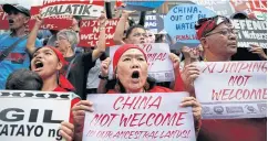 ?? REUTERS ?? LEFT Protesters chant slogans during a rally outside the Chinese Consulate in Makati, Metro Manila.