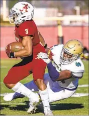  ?? Robert Gauthier Los Angeles Times ?? SHERMAN OAKS Notre Dame’s Sulayman Adeoye brings down Bishop Alemany’s Floyd Chalk IV.