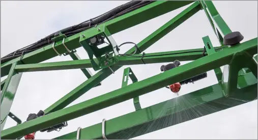  ?? ?? under the boom detects weeds and spot sprays accordingl­y in John Deere’s new See and Spray technology