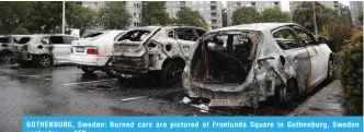  ?? — AFP ?? GOTHENBURG, Sweden: Burned cars are pictured at Froelunda Square in Gothenburg, Sweden yesterday.