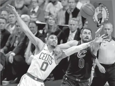  ?? WINSLOW TOWNSON / USA TODAY SPORTS ?? Boston Celtics’ Jayson Tatum battles Cleveland Cavaliers’ Kevin Love for a rebound during Wednesday’s Game 5 of the NBA Eastern Conference final in Boston. The Celtics won 96-83 to take a 3-2 lead in the best-of-seven-series.