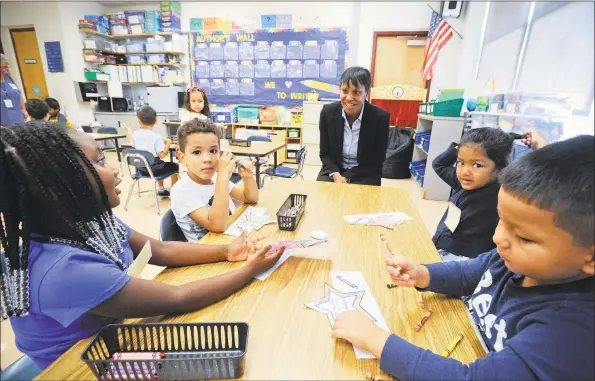  ?? Matthew Brown / Hearst Connecticu­t Media file photo ?? Stamford Superinten­dent of Schools Tamu Lucero chats with kindergart­ners at KT Murphy School in Stamford on the first day of school on Aug. 29, 2019.