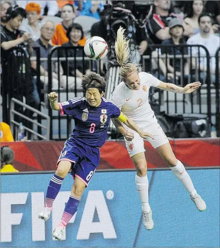  ?? MARK VAN MANEN /PNG ?? Japan’s Aya Miyama, left, goes up for a header with Desiree van Lunteren of the Netherland­s during Women’s World Cup action on Tuesday night at B.C. Place. Japan prevailed 2-1.