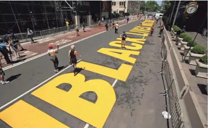  ?? MARK LENNIHAN/AP ?? Black Lives Matter is painted on Fifth Avenue in front of Trump Tower on July 9 in New York City.