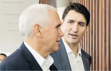  ?? — THE ASSOCIATED PRESS ?? U.S. Vice-President Mike Pence and Prime Minister Justin Trudeau arrive together Saturday at APEC Haus in Port Moresby, Papua New Guinea.