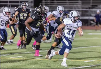  ?? Cory Rubin/The Signal ?? West Ranch senior Reiger Burgin takes it to the house in a Foothill League match-up with Golden Valley at Harry Welch Stadium on Friday night. The Wildcats defeated the Grizzlies 52-13