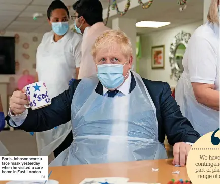  ?? PA ?? Boris Johnson wore a face mask yesterday when he visited a care home in East London