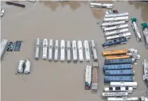  ?? Brett Coomer / Houston Chronicle ?? These industrial vehicles in Houston were in floodwater­s last month from Harvey. The EPA maintains a program called IRIS to assess the health risks of various chemical compounds.