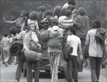  ?? New York Daily News via Getty Images ?? The original caption to this photo from the New York Daily News: “They’re Going Home Loaded. After a week of drugs and disappoint­ment, youths abandon the Powder Ridge ski area in Middlefiel­d yesterday. The rock festival, which had been scheduled, had long been canceled by court order. But 30,000 squatters had gone to site anyway. It turned out to be a bad trip.”