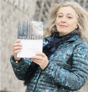  ?? TROY FLEECE ?? Susan Birley of the Friends of the Regina Public Library holds up a copy of the book she co-wrote, Biblio Files: A History of the Regina Public Library. The book’s publicatio­n marks the facility’s centennial.