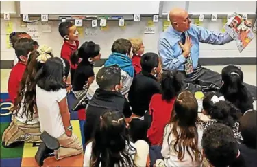  ?? NEWS-HERALD FILE ?? Painesvill­e Superinten­dent John Shepard reads to students at Elm Street Elementary School. Painesvill­e Schools saw growth in multiple areas on the 2016-17 Ohio School Report Card, especially in K-3 literacy.