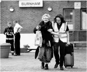  ?? REUTERS ?? A resident is evacuated from the Burnham Tower residentia­l block in London as a precaution­ary measure