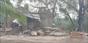  ??  ?? Damaged buildings are pictured from inside a vehicle after Cyclone Kenneth swept through the region in Cabo Delgado province. — Reuters photo