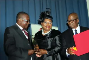  ??  ?? Mr. Bashir Wali, Acting MD/CEO, NEXIM Bank receiving a plaque of honour from Mr. & Mrs. Adegboyega Awomolo (SAN) at the 3rd Awomolo Annual Colloquium in Abuja recently