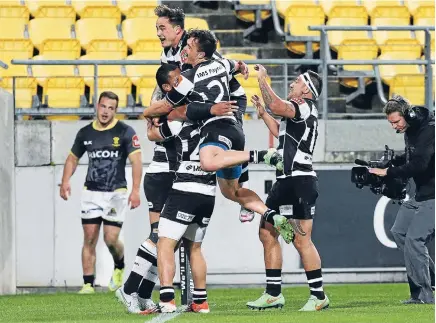  ?? Photo: GETTY IMAGES ?? Delighted Hawke’s Bay players celebrate Robbie Fruean’s 79th-minute try that gave their side a 22-22 draw against Wellington last night.