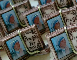  ??  ?? LEFT OUT: Souvenirs depicting Mother Theresa. She is a significan­t omission from Great People of Faith and Wisdom: How their Lives changed our Lives, says the writer. Picture: REUTERS