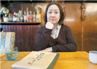  ?? AFP-Yonhap ?? Danish adoptee, 47-year old May-Britt Koed poses as her adoption files are seen on a table in Copenhagen, Denmark, Jan. 30.