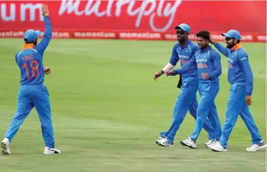  ??  ?? HEAD START: India’s Kuldeep Yadav is congratula­ted by teammates after taking a wicket during the second ODI against South Africa at Centurion on Sunday. The tourists won by a massive nine wickets to take a 2-0 lead in the six-match series.