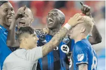  ?? FRED THORNHILL/THE CANADIAN PRESS ?? Impact players celebrate after defeating Toronto FC 1-0 on Saturday.