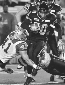  ?? MIKE CASSESE/ REUTERS ?? Hamilton Tiger-Cats wide receiver Chris Williams breaks a tackle during the first half of Hamilton’s 41-28 win on Friday night.