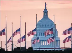  ?? J. DAVID AKE/THE ASSOCIATED PRESS ?? Flags fly at half-mast in honour of Sen. John McCain at the U.S. Capital at daybreak in Washington.