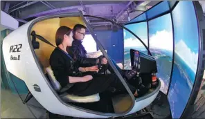  ?? XINHUA ?? Working staff operate a flight simulator at the virtual reality technology center of the service outsourcin­g industry base in Langfang, Hebei province.