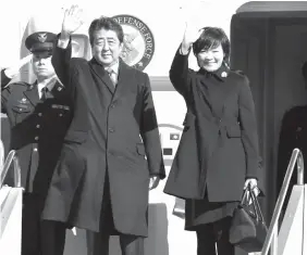  ?? AGENCE FRANCE PRESSE ?? Japanese Prime Minister Shinzo Abe and his wife Akie wave as they leave Tokyo’s Haneda airport for a tour to Baltic states and other European nations.