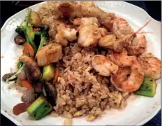  ?? Arkansas Democrat-Gazette/JENNIFER CHRISTMAN ?? The Samurai Seafood Feast, served here with fried rice and vegetables, includes shrimp, scallops and lobster tail.