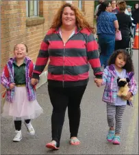  ?? Photo by Joseph B. Nadeau ?? Jenna Daignault walks her daughter Madelyn, 5, left, and Lily Jay, 4, right, to the Bernon Heights Elementary School on Wednesday where Madelyn was starting kindergart­en. “I’m nervous and excited at the same time,” Daignault noted. “It is our first...