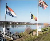  ?? VIRGINIA MAYO/AP ?? The Dutch and Belgian flags, from left, are displayed last month in the border town of Eijsden, Netherland­s.