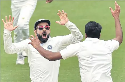  ?? AFP ?? India captain Virat Kohli, left, celebrates with spin bowler Ravichandr­an Ashwin after beating Australia at Adelaide Oval yesterday.