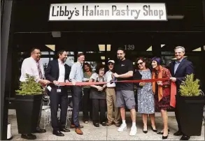  ?? Arnold Gold / Hearst Connecticu­t Media ?? Marc D’Angelo, co-owner of Libby’s Italian Pastry Shop, cuts the ribbon Wednesday celebratin­g the 100th anniversar­y of the Wooster Street bakery in New Haven.