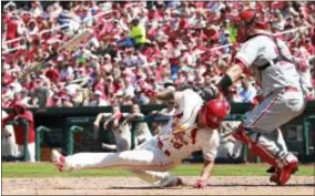  ?? CHRIS LEE — ST. LOUIS POST-DISPATCH VIA AP ?? St. Louis’ Carlos Martinez is hit by a pitch in the seventh inning Phillies during Saturday’s game at Busch Stadium in St. Louis. against the