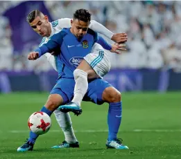  ??  ?? Real Madrid’s Theo Hernandez ( background) vies for the ball with Hugo Fraile of Fuenlabrad­a in their Spanish Copa del Rey round of 32 second leg match at the Santiago Bernabeu Stadium in Madrid, on Tuesday.