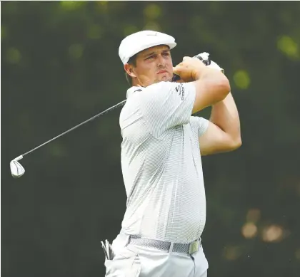  ?? GREGORY SHAMUS/GETTY IMAGES ?? Bryson Dechambeau drives from the 11th tee during the first round of play at the Rocket Mortgage Classic on Thursday at the Detroit Golf Club. The American delivered a blistering back nine in carding a 6-under 66 for the day, leaving him within a stroke of the lead.