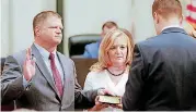  ?? [PHOTO BY CHRIS LANDSBERGE­R, THE OKLAHOMAN] ?? Oklahoma City Ward 4 Councilman Todd Stone stands with his wife, Mariann, as he takes the oath of office Tuesday for his four-year term on the Oklahoma City Council at City Hall in Oklahoma City.