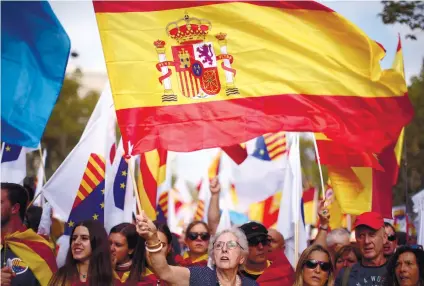  ?? CELEBRATIO­N. A woman waves a Spanish flag while celebratin­g a holiday known as “Dia de la Hispanidad” or Spain’s National Day in Barcelona. AP FOTO ??