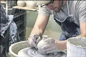  ?? MARY ANN ANDERSON ?? Pigeon River Pottery at the Old Mill in Pigeon Forge features artisans hard at work at their craft.