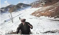  ?? WONG MAYE-E/AP ?? In 2015, village elder Song Hong Ik walks past a hill in Kujang County, North Korea, where remains of U.S. military personnel from the Korean War might be buried.