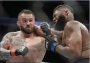  ?? JOHN LOCHER — ASSOCIATED PRESS ?? Daniel Omielanczu­k, left, hits Curtis Blaydes in a heavyweigh­t mixed martial arts bout July 8 at UFC 213 in