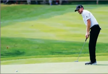  ?? The Associated Press ?? WALKING PACE: Jimmy Walker watches his birdie putt on the third hole during the first round of the PGA Championsh­ip Thursday at Baltusrol Golf Club in Springfiel­d, N.J. Walker shot 5-under-par 65 for a one-shot lead over a three-way tie for second place.