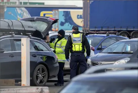  ??  ?? Customs officers at Dublin Port carrying out post Brexit checks.