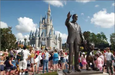  ?? PHELAN M. EBENHACK — THE ASSOCIATED PRESS FILE ?? In this file photo, tourists crowd around Cinderella’s Castle to watch a performanc­e at Walt Disney World’s Magic Kingdom in Lake Buena Vista, Fla. Anyone planning a Disney trip can get free, customized advice from the Disney Parks Moms Panel about...